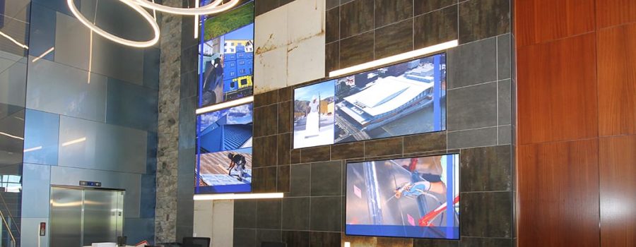 Archetype Glass' custom art glass wall cladding on the reception wall at CCM Training and Education Center