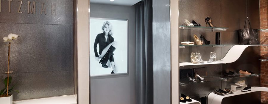 A wide view of the custom art glass wall cladding at Stuart Weitzman Soho, crafted by Archetype Glass