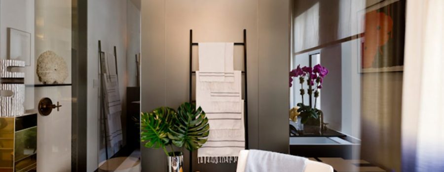 The custom decorative mirrored shower wall cladding by Archetype Glass for Kips Bay Show House