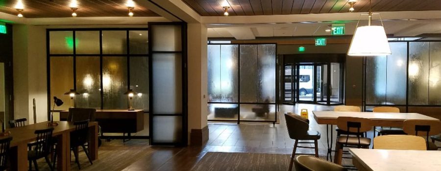 A wide view of the custom laminated art glass partition walls at the Verizon Basking Ridge Hotel Restaurant, by Archetype Glass