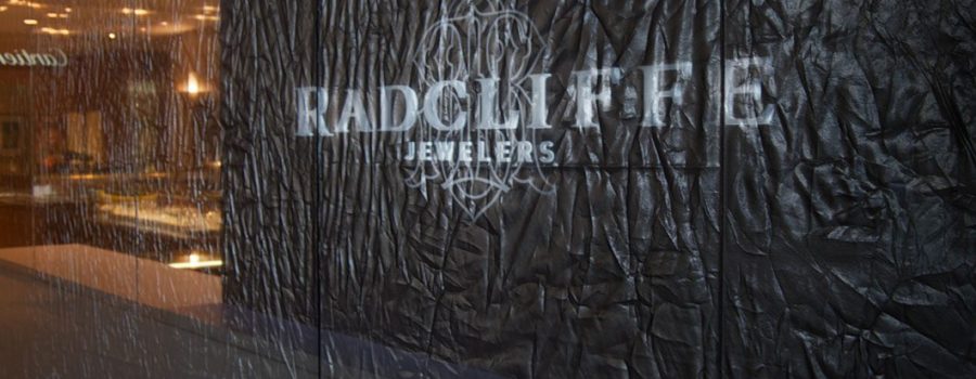 The elegant effect created by Archetype Glass' custom fabric laminated glass partition wall for Radcliffe Jewelers boutique retail entrance