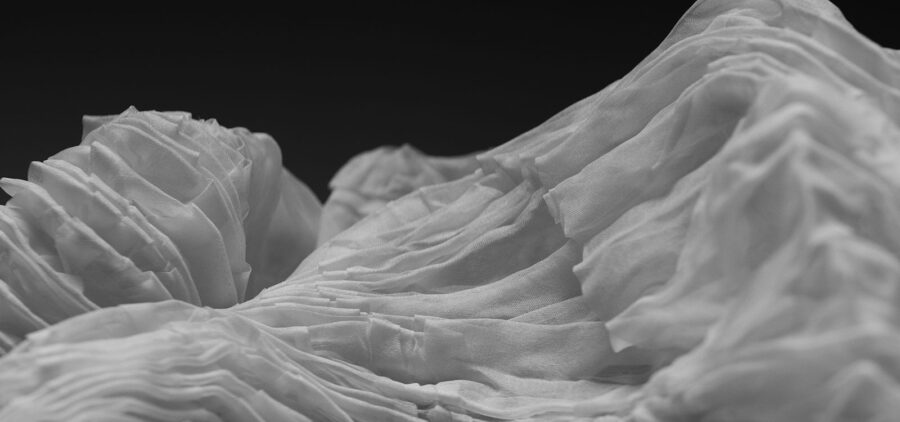 Archetype Glass announces an exclusive collaboration with Spatial Element folded and pleated fabric for its custom laminated glass