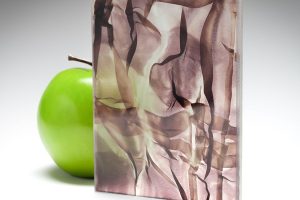 A wine-colored sample of the new barely transparent custom fabric glass in coordination with Spatial Element.