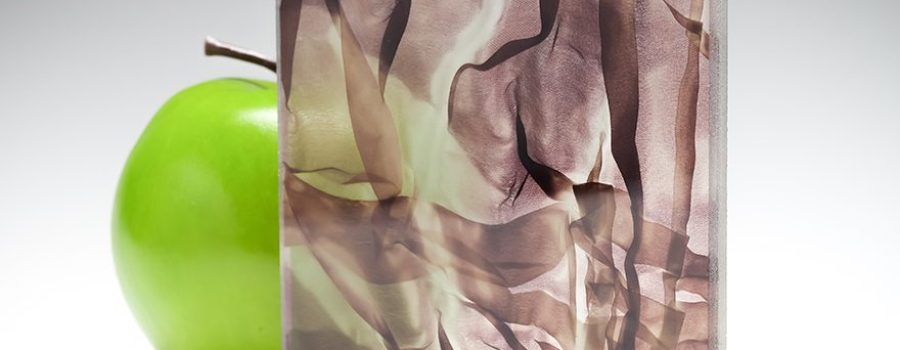 A wine-colored sample of the new barely transparent custom fabric glass in coordination with Spatial Element.