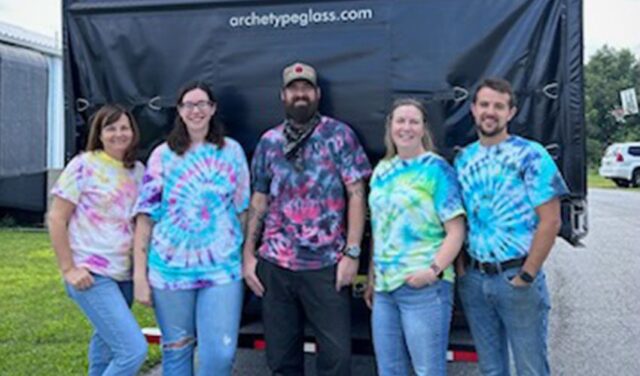 The team at Archetype Glass, experts in custom laminated glass, celebrating their Tie Dye Team Picnic,