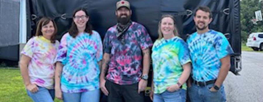 The team at Archetype Glass, experts in custom laminated glass, celebrating their Tie Dye Team Picnic,