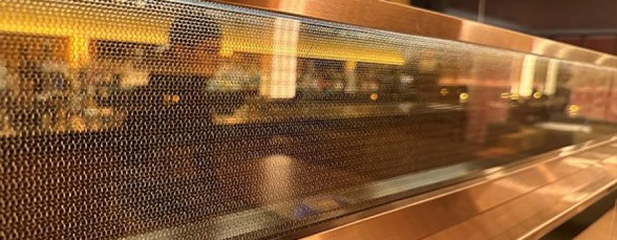 A close view of the custom laminated wire mesh glass used in the Coqodaq restaurant, recently featured in Hospitality Design Magazine